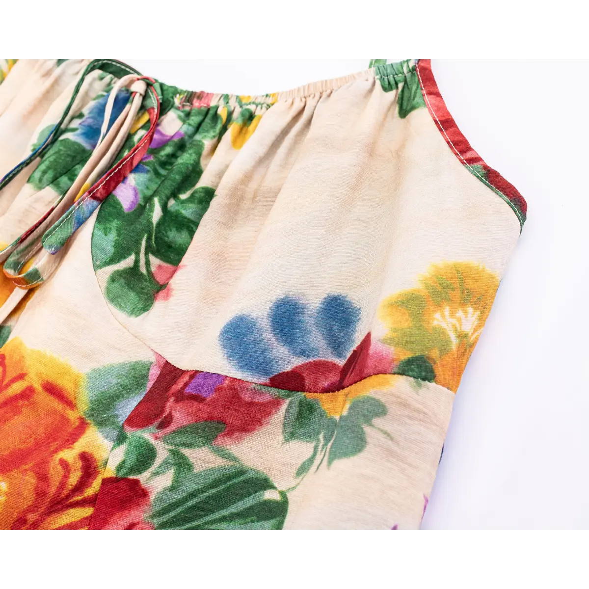 Close-up of the front gathered bust with self-fabric drawstring tie on vintage watercolor floral print spaghetti strap maxi dress.