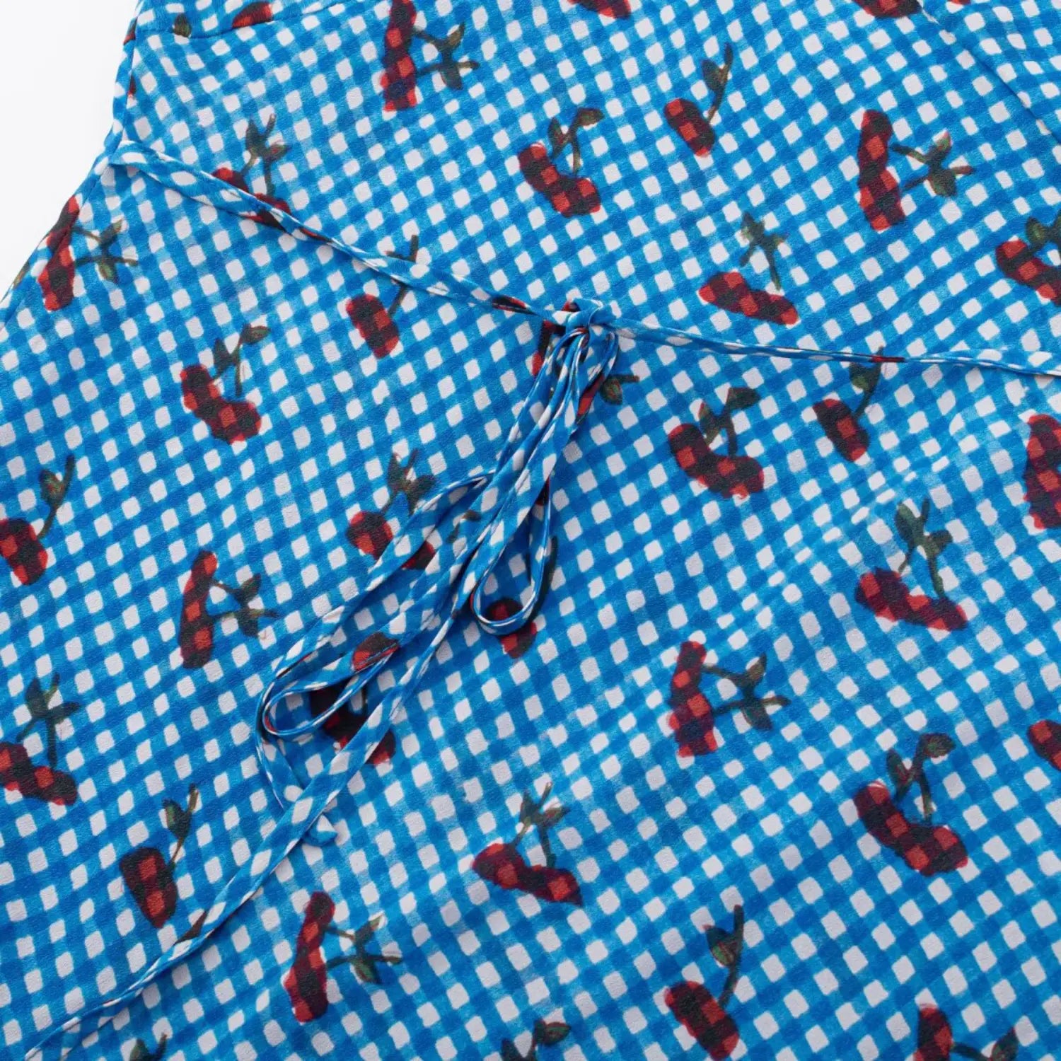Dress front waist drawstring macro close-up, matching print fabric tie adjustable tightness waist shaping fabric drape shot