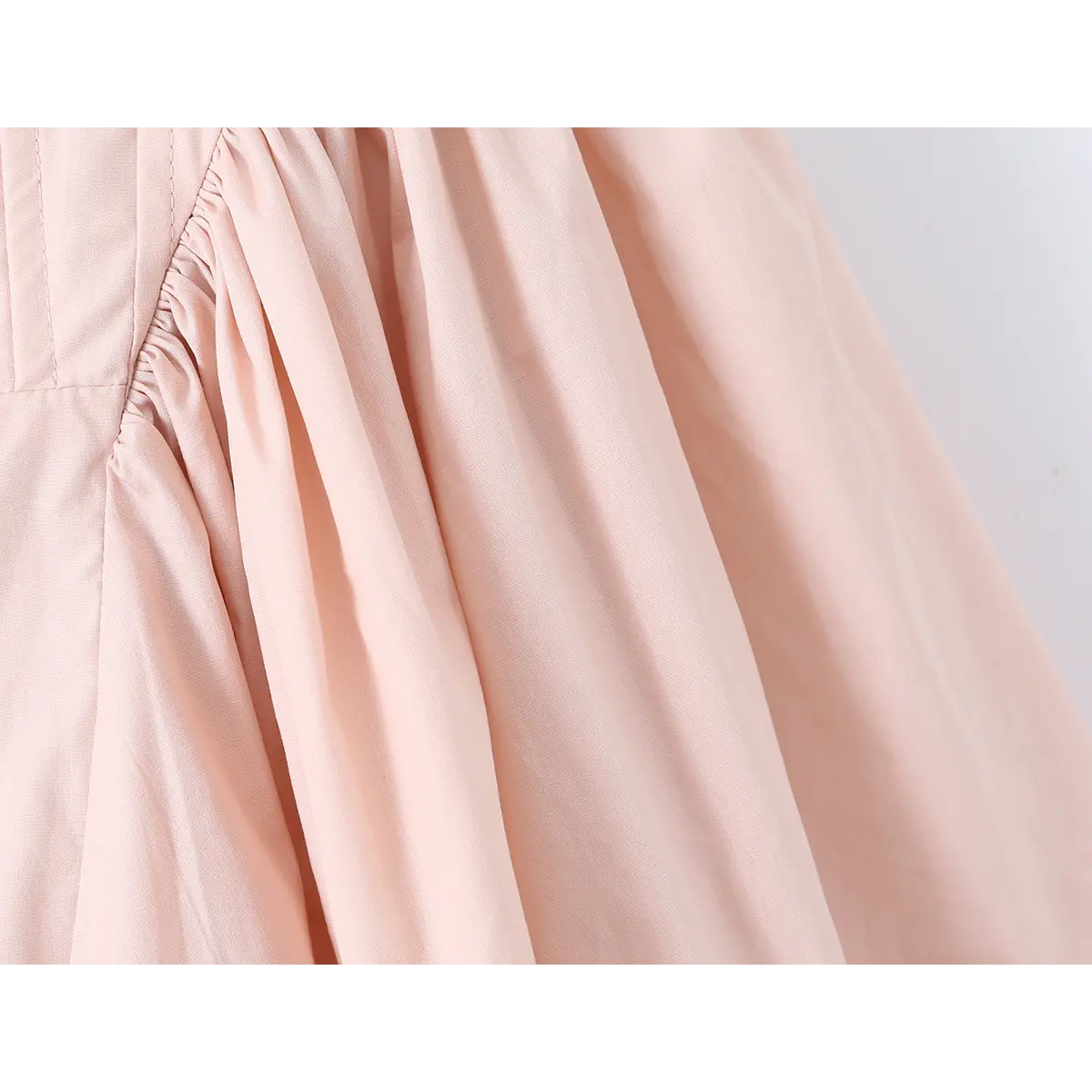 Close-up of the gathered waist seam where the corset bodice meets the bubble skirt.
