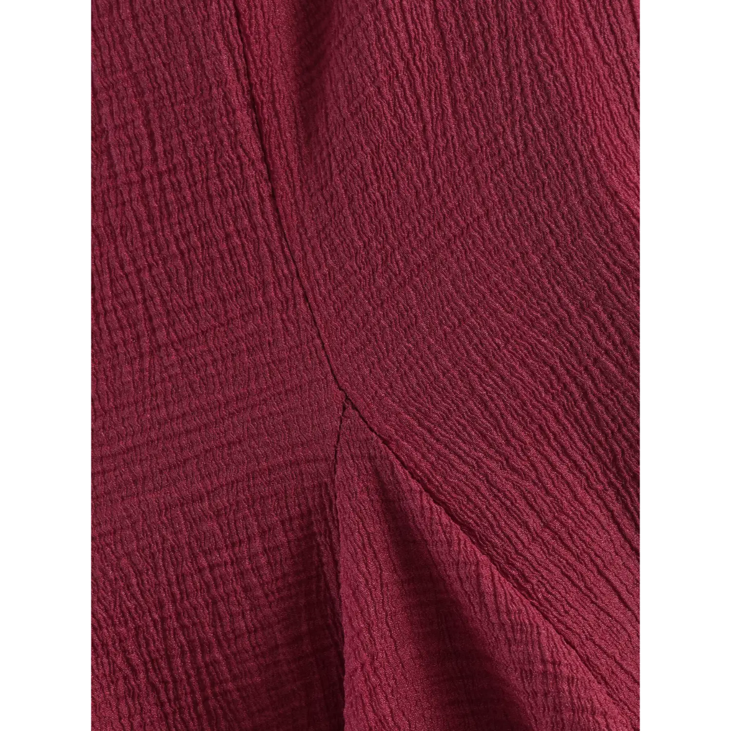 Waist hip partial shot intersecting vertical and horizontal shaping seams, continuous uniform crinkle weave across panels