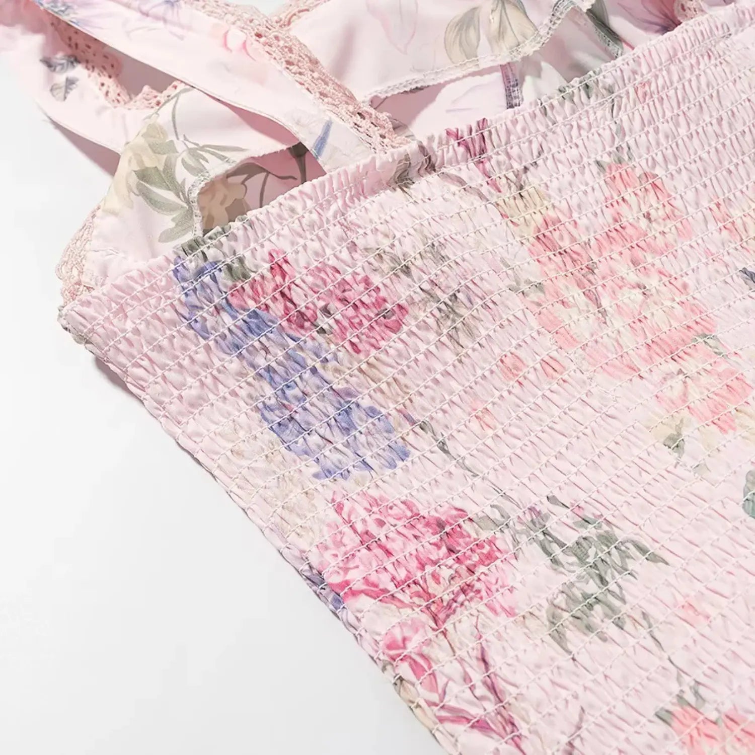 Side waist smocked shirring close-up, dense elastic ruched stitching for stretch fit, floral print woven base fabric
