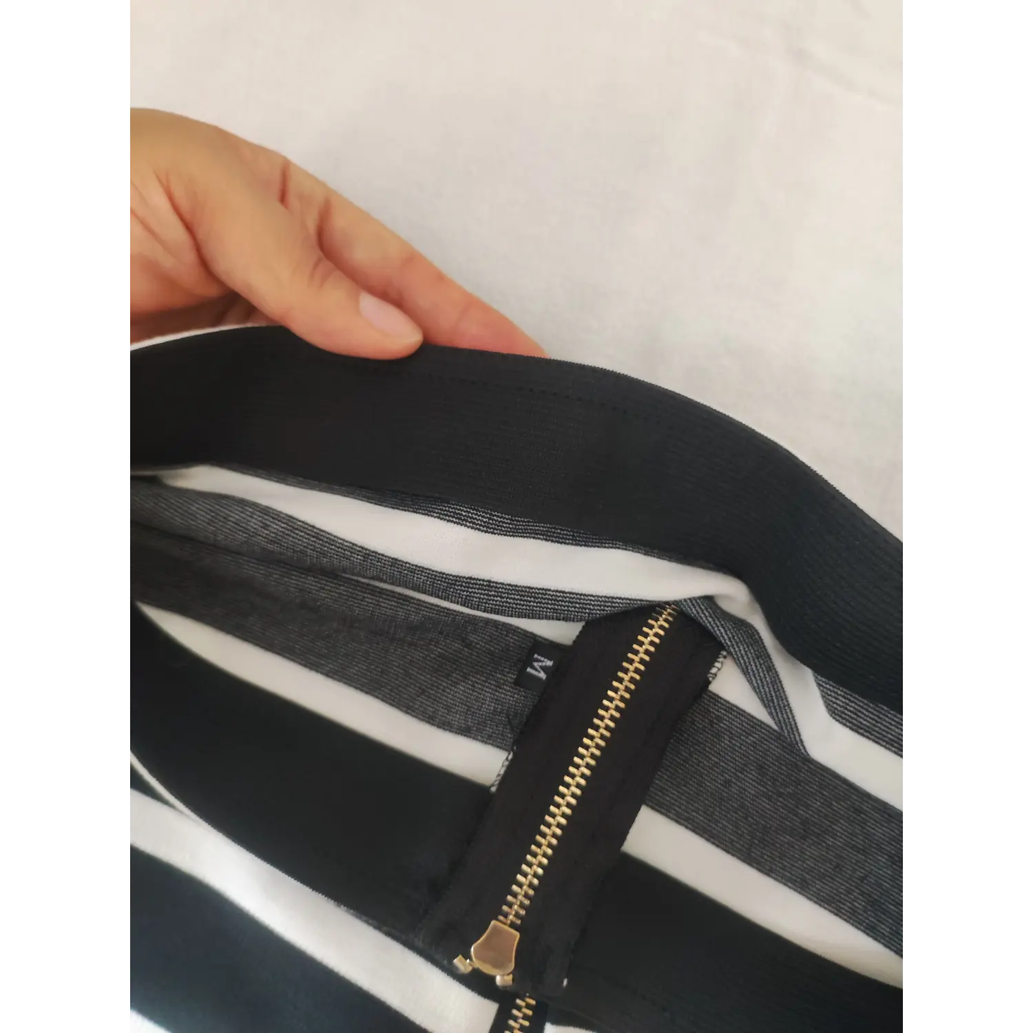 Inner waistband label and zipper detail black white striped midi skirt
