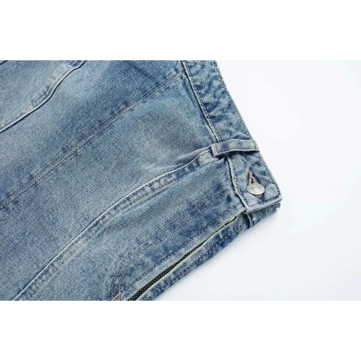 Close-up of the metal button and waistband loop on the washed denim strapless top.