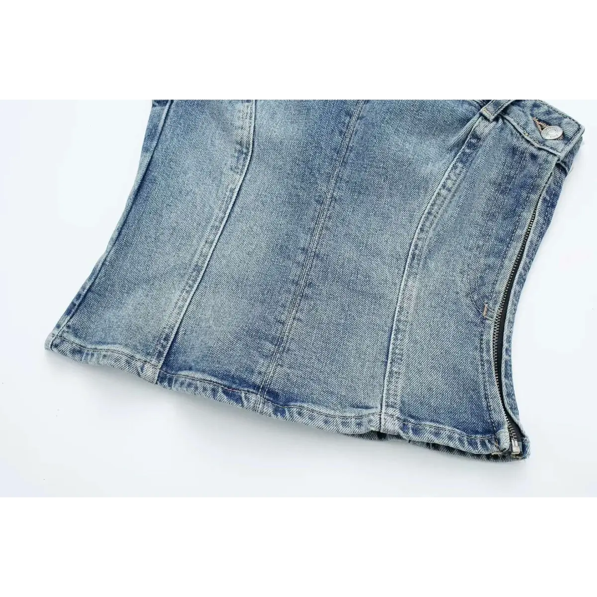 Full studio shot of the washed denim strapless bustier top, showing the corset-style seamed silhouette.