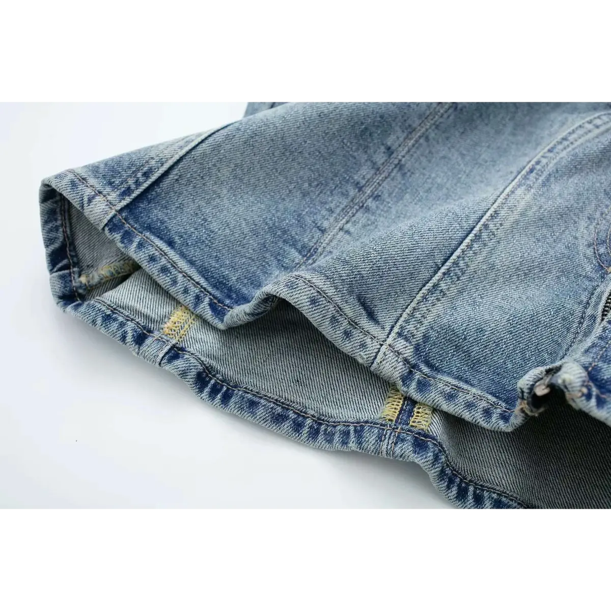 Close-up of the stitching and seam construction on the washed denim bustier top.