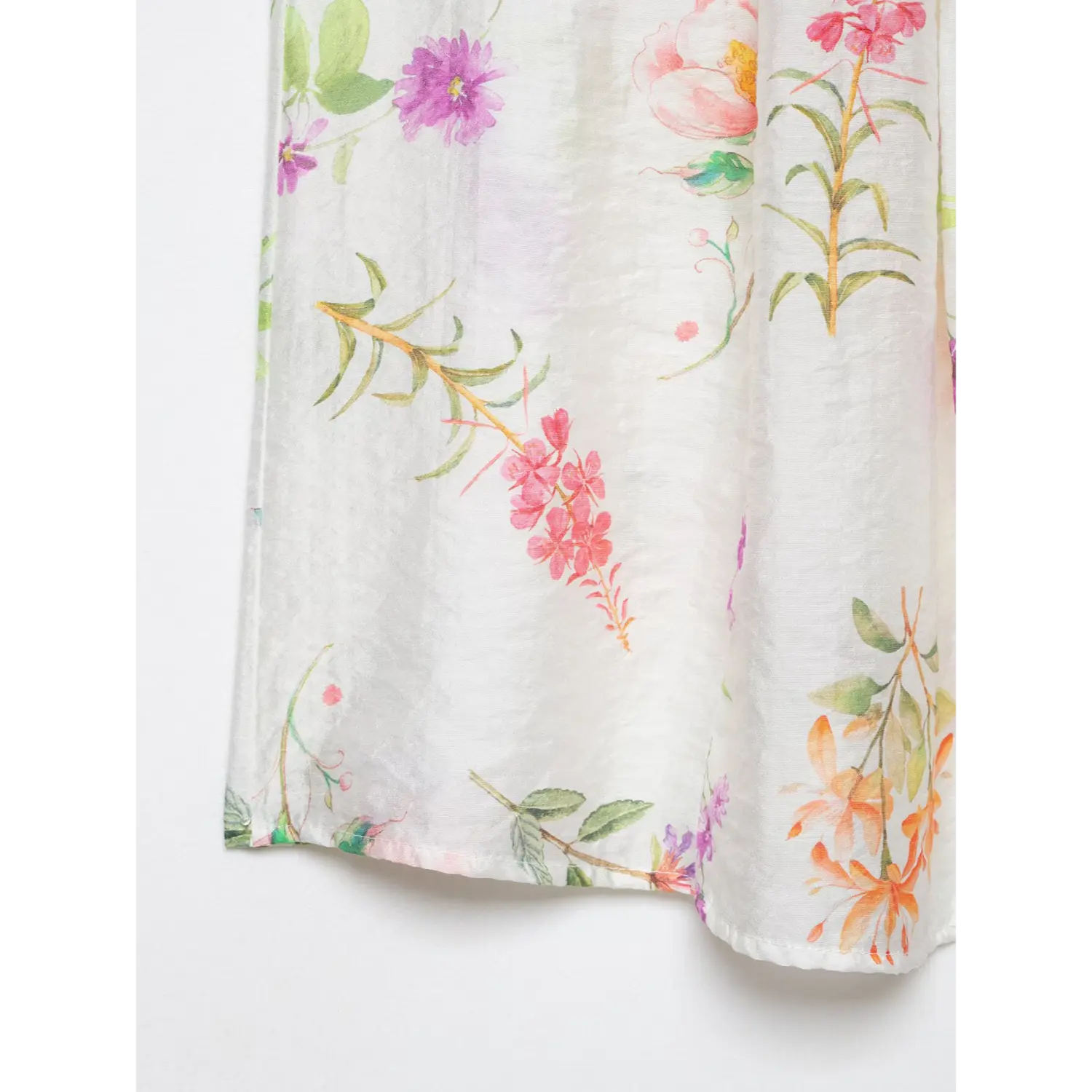 Macro close-up of hem side panel, soft watercolor wild flower & leaf print, subtle wrinkled lightweight woven fabric, neat finished bottom hem stitching