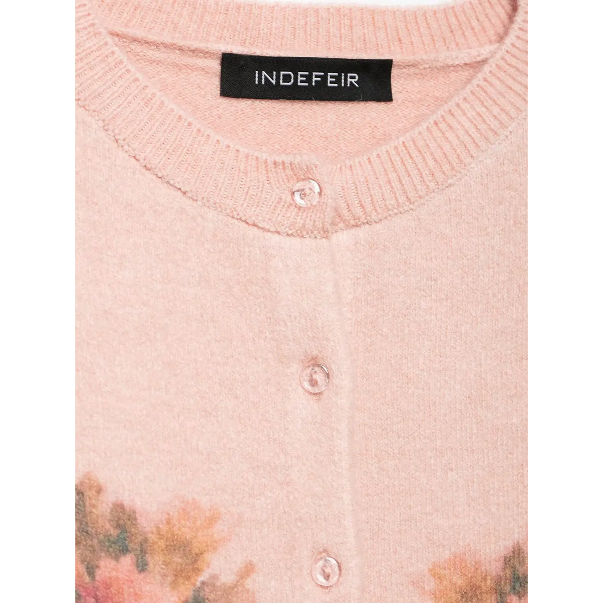 Close-up of neck label and transparent pink buttons