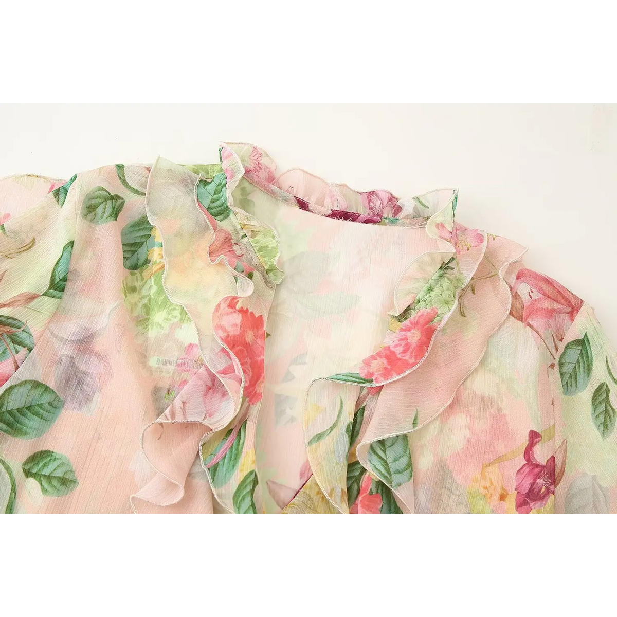 Close-up of ruffled v-neck and front ruffle trim
