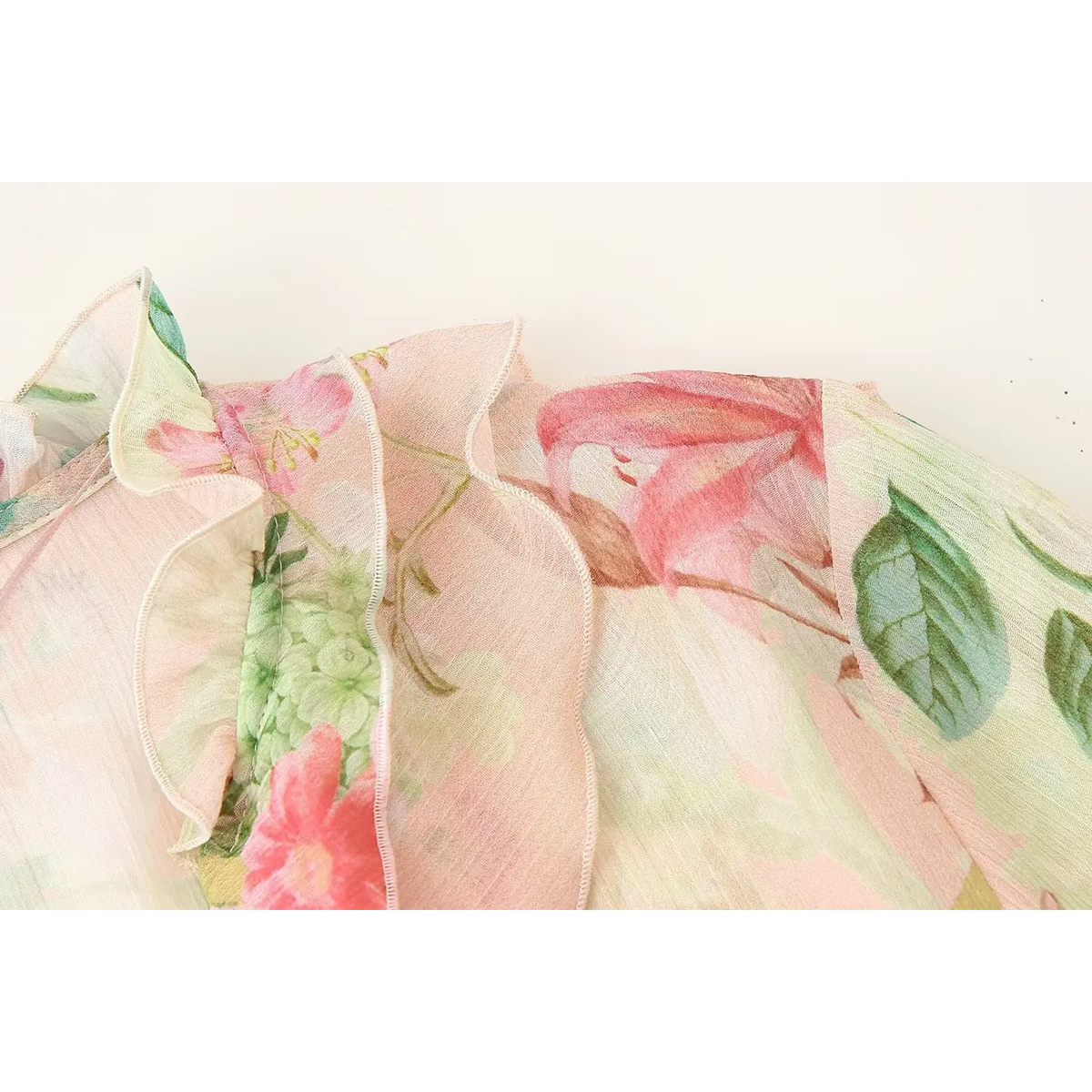 Close-up of shoulder ruffle and floral print