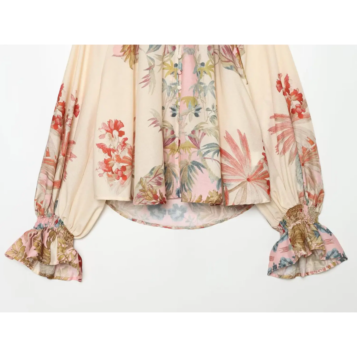 Close-up of curved hem, balloon sleeves and ruffle cuffs