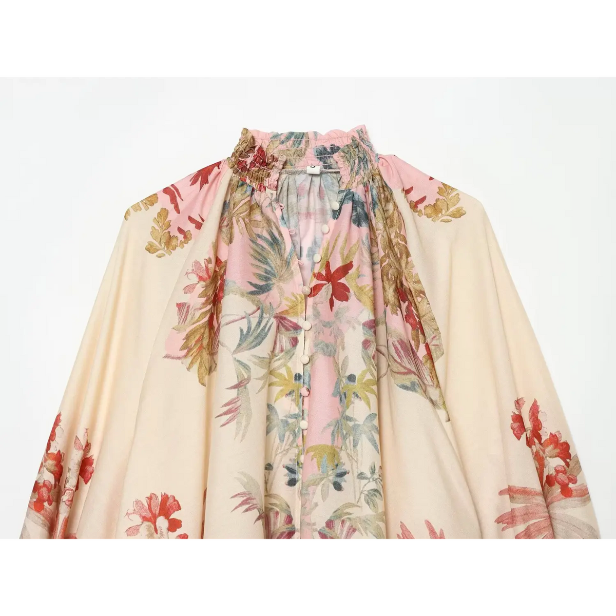 Close-up of smocked high neck, button placket and floral print