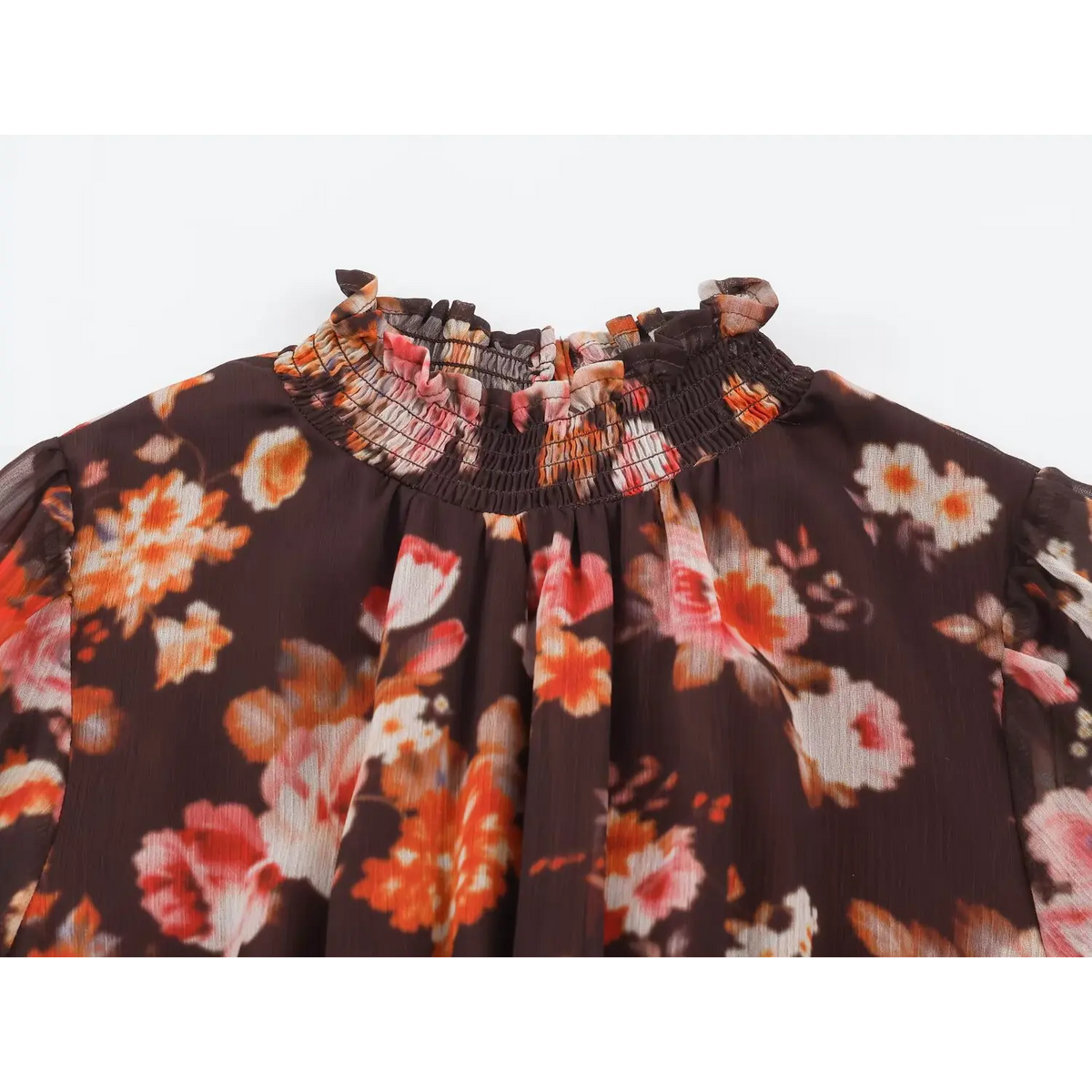 Close-up of smocked ruffled high neck and gathered bodice