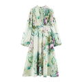 Full look of watercolor floral maxi dress with stand collar, puff sleeves and flowing skirt
