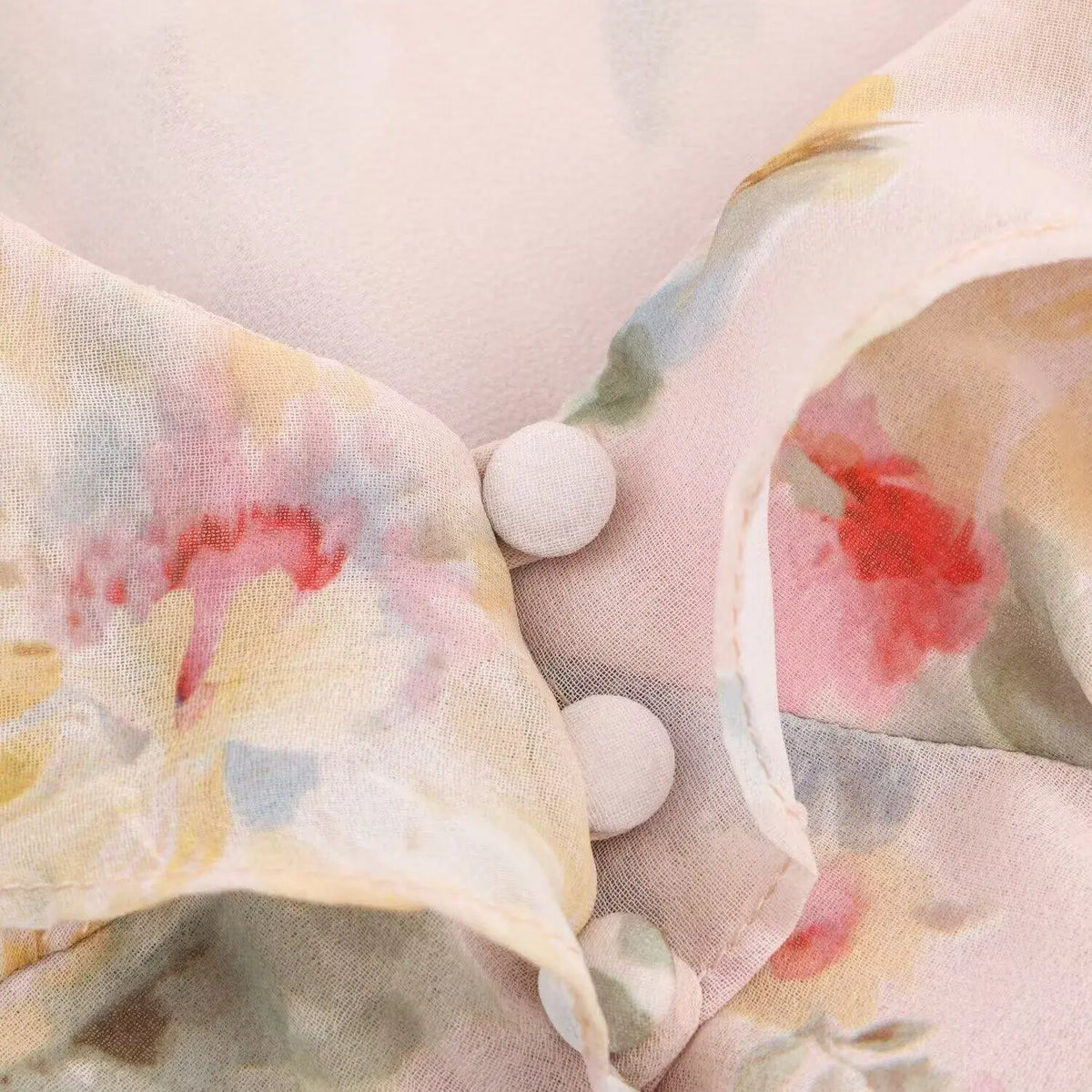 Close-up of covered buttons on front placket