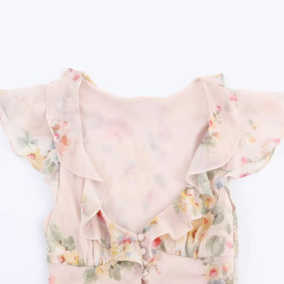 Close-up of V neckline ruffle trim and button placket