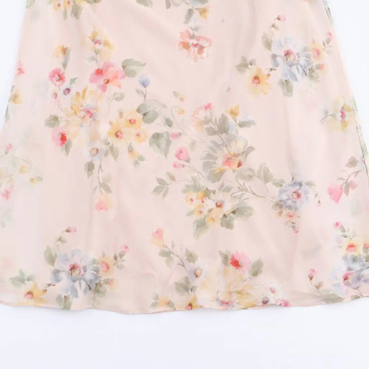 Close-up of watercolor floral print on flowing skirt