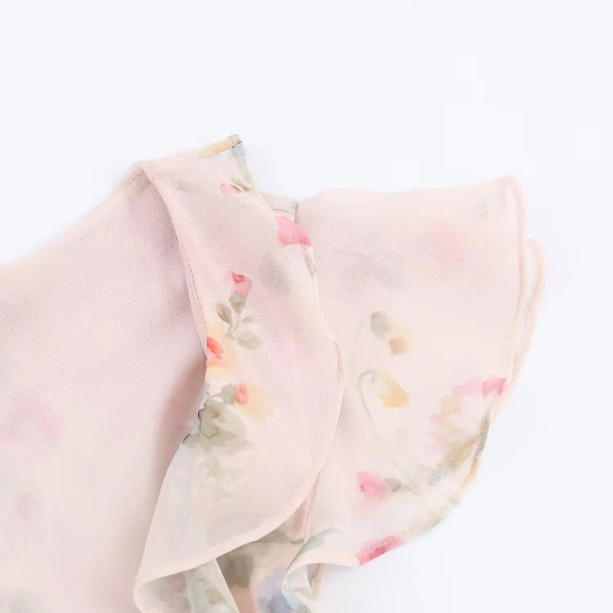 Close-up of shoulder ruffle and flutter sleeve