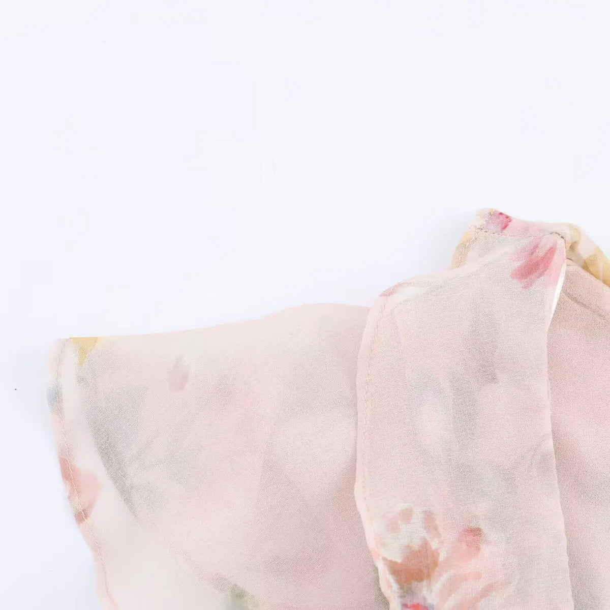 Close-up of flutter sleeve and chiffon hem