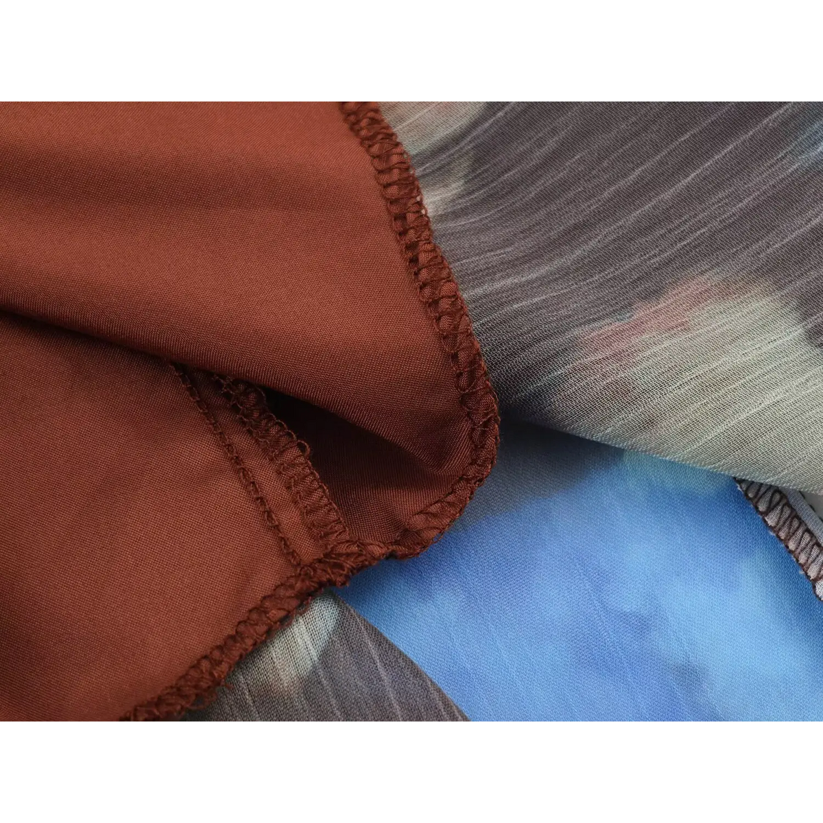 Close-up view of back high neck zipper on multicolor watercolor print pleated chiffon maxi dress