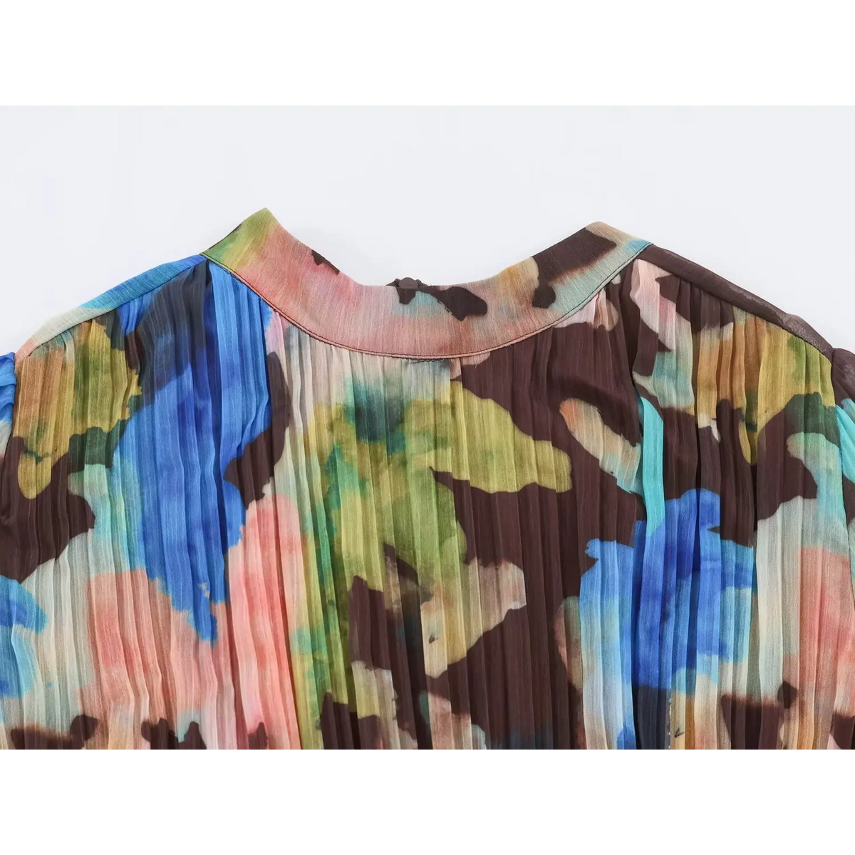 Close-up of high neckline and shoulder area on multicolor watercolor pleated maxi dress