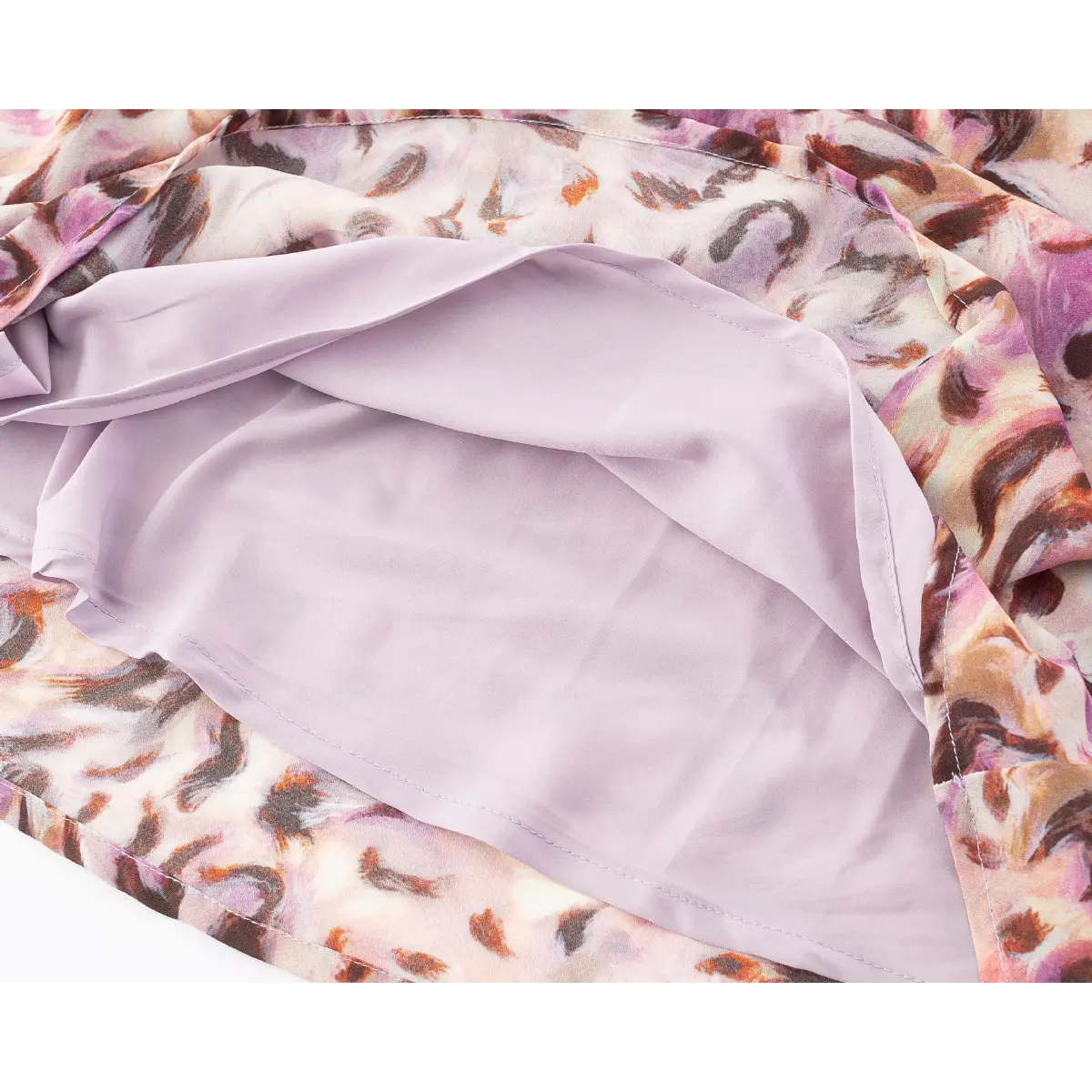Close-up of the smooth light purple lining beneath the sheer printed outer fabric.