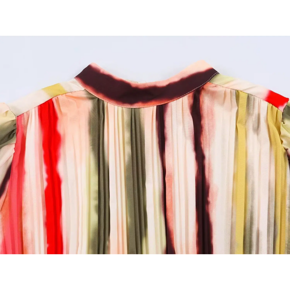 Close-up of mock neck and pleated bust