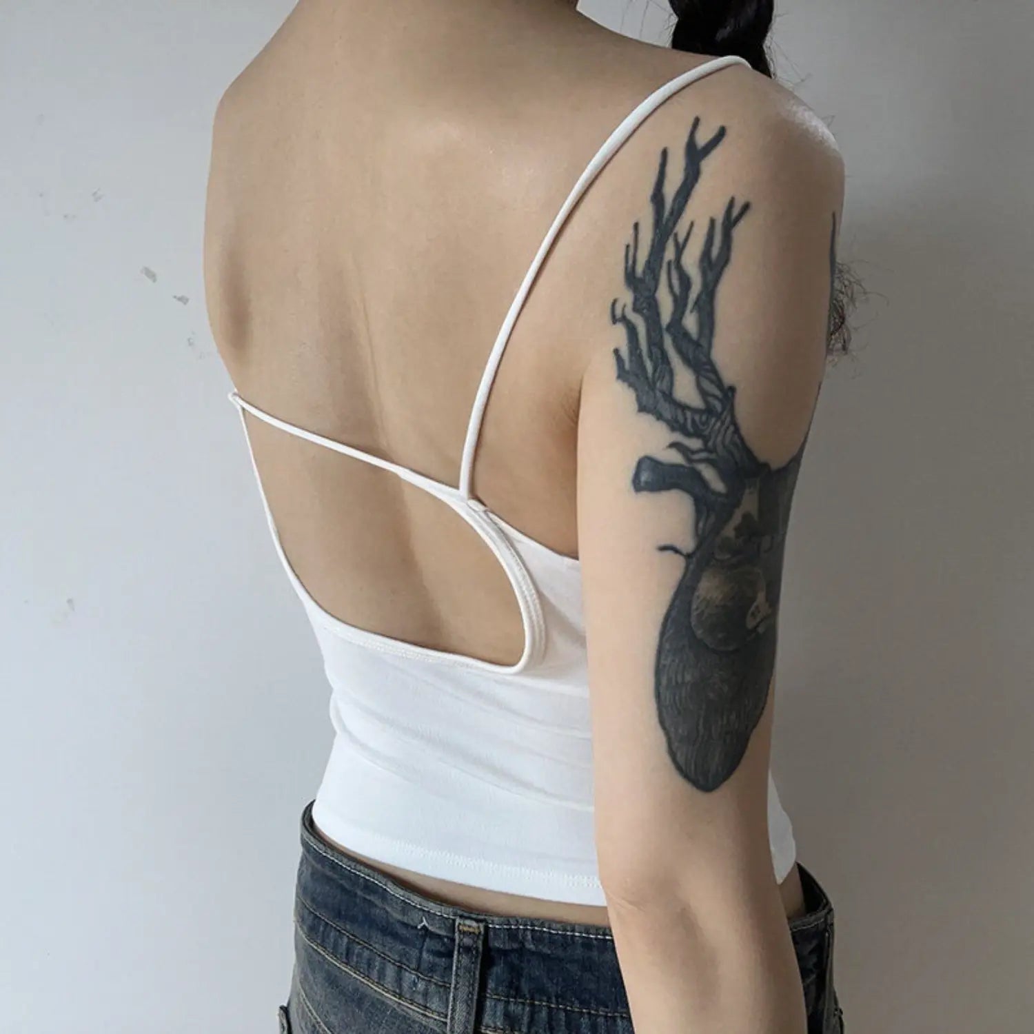 White backless v-neck camisole full back model shot, wide u cross hollow back cross chest thin tie strap design flat rib back ruched slim cropped fit outfit reference