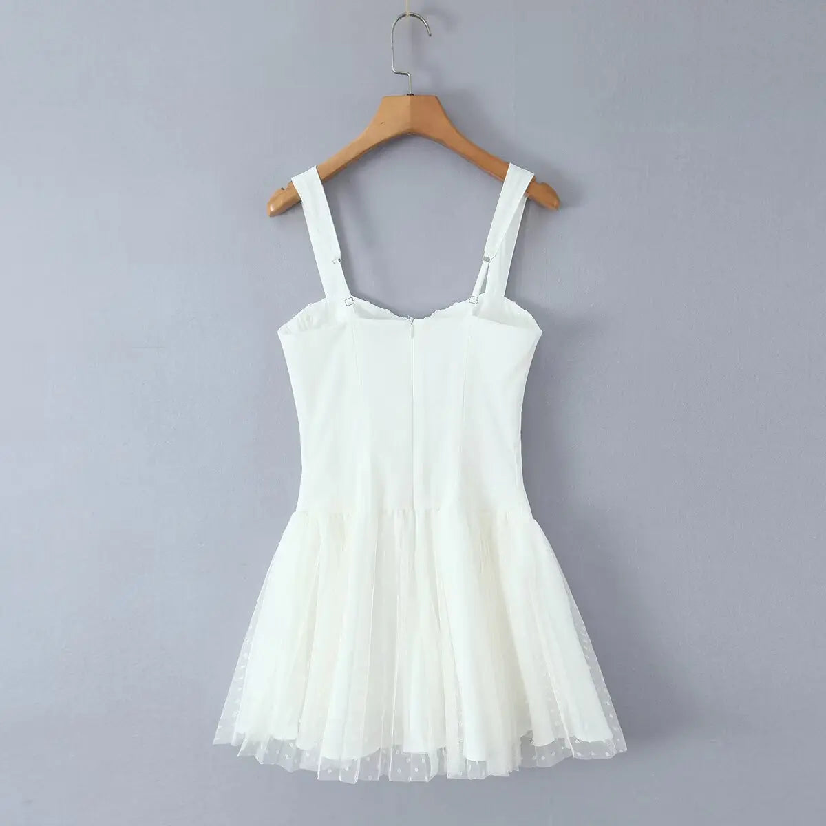 Full back view showing the central zipper closure, adjustable straps, and tiered tulle skirt.