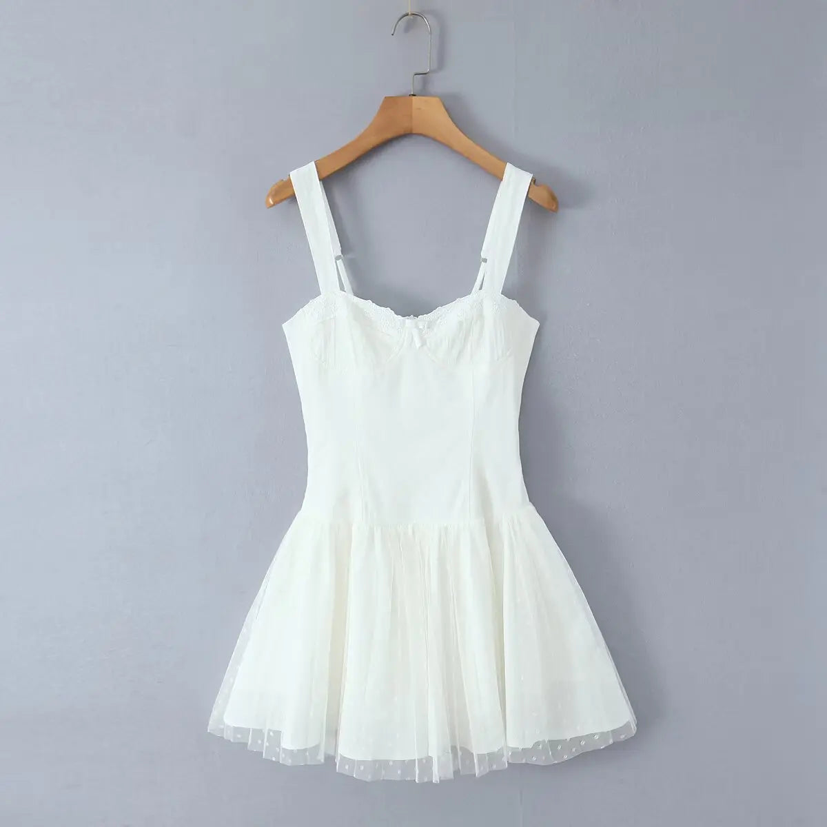 Hanging front view showing adjustable wide straps, fitted bodice, and layered tulle skirt.