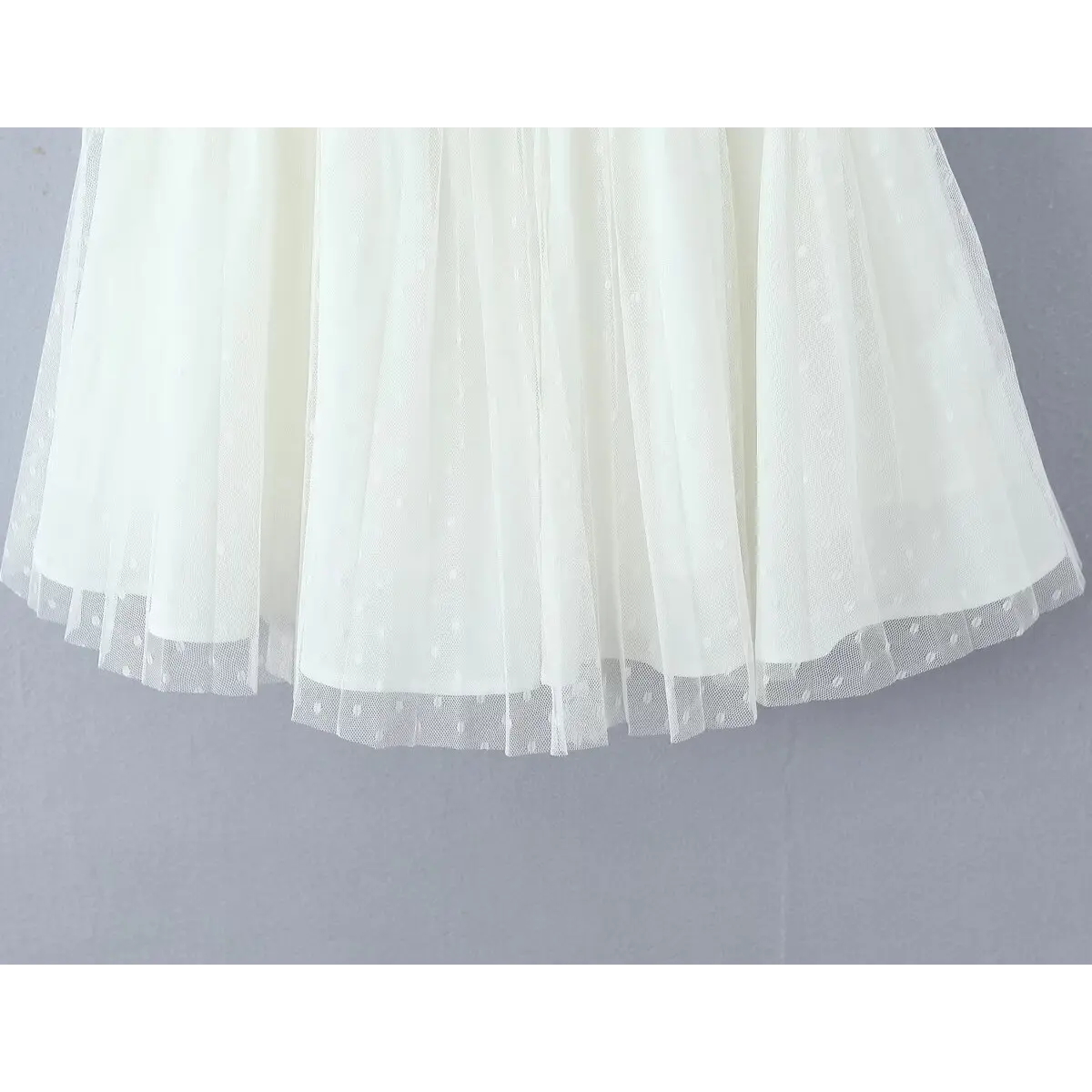 Close-up of the flared A-line skirt, showcasing the layered dotted mesh tulle and soft drape.