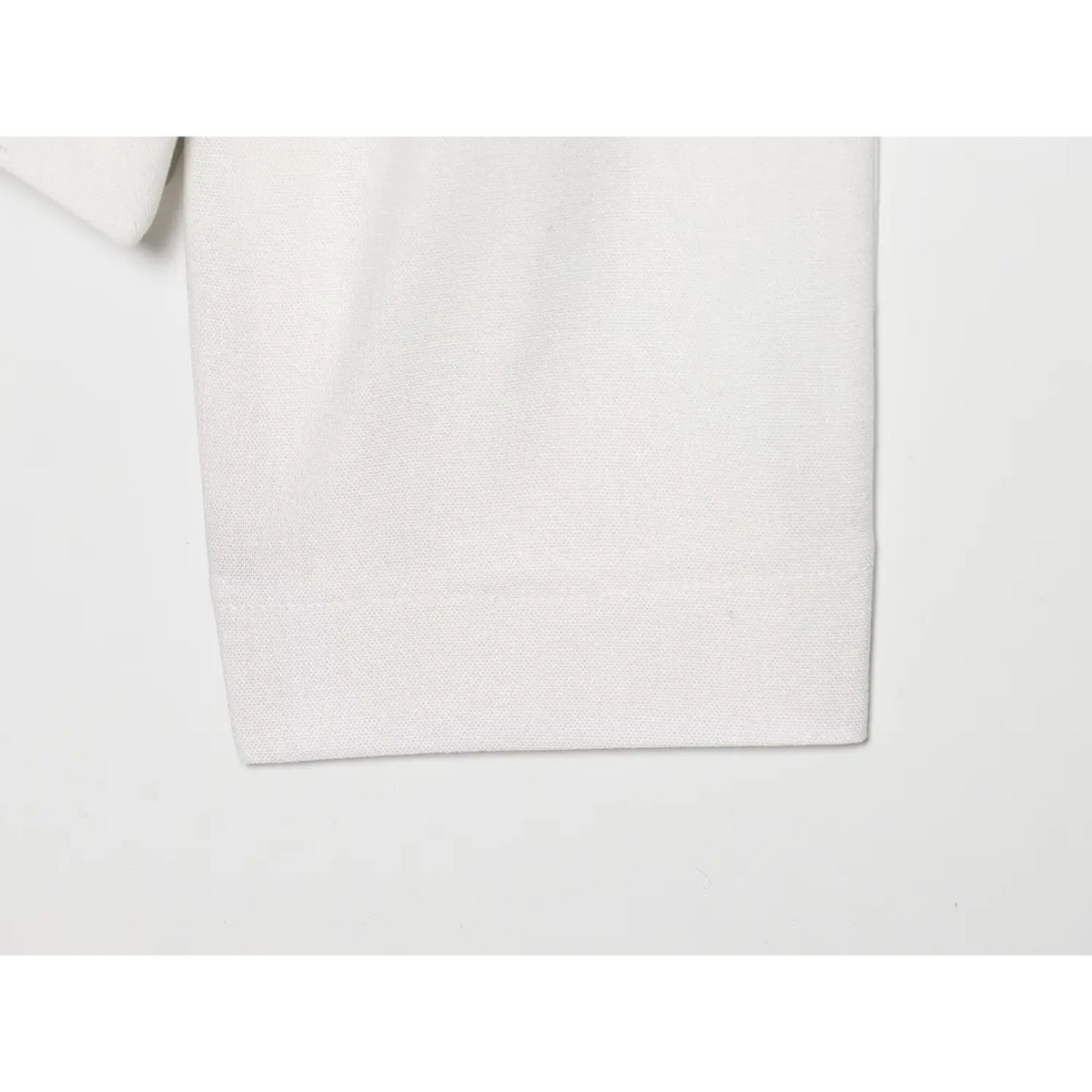 Close-up of folded cuff and textured fabric