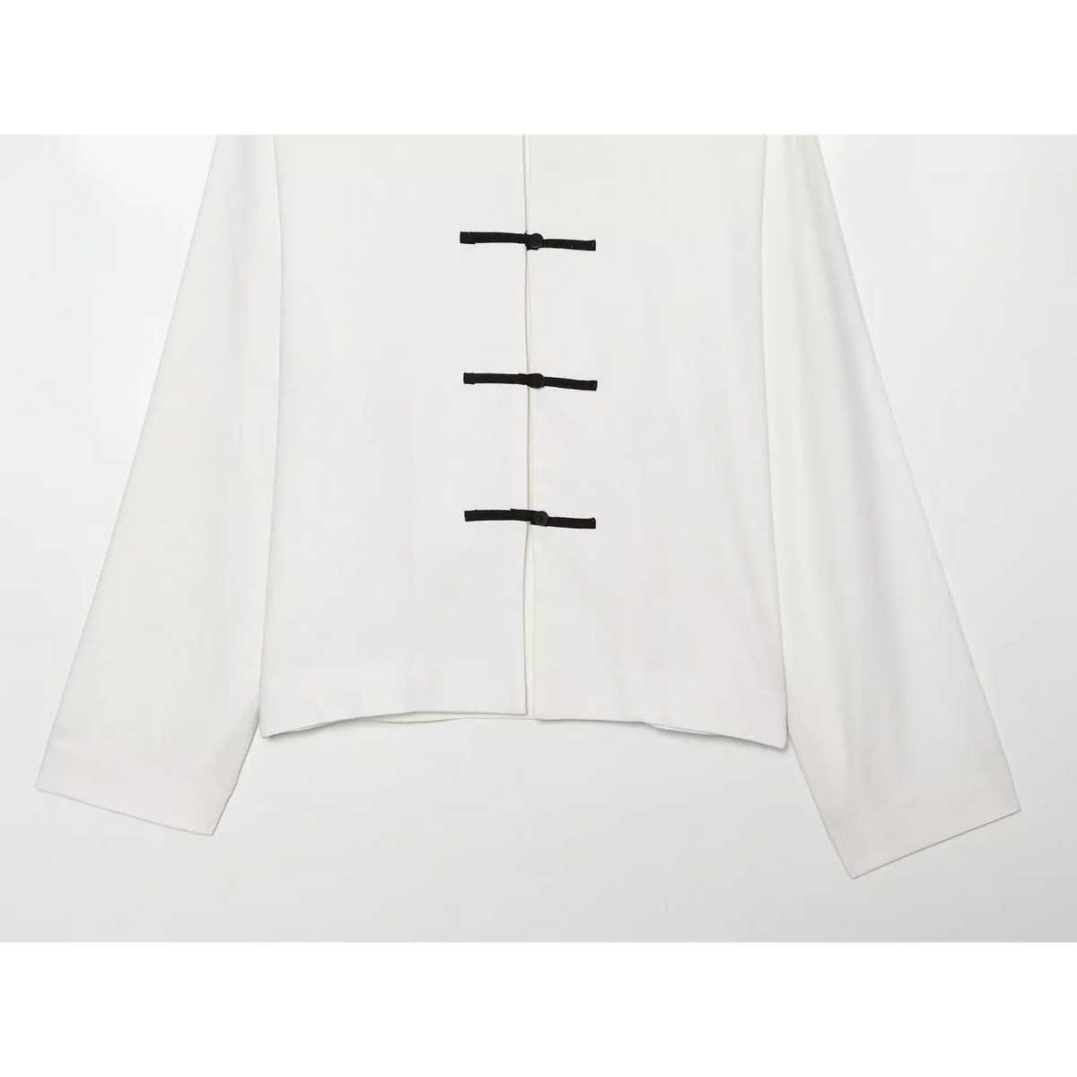 Close-up of frog button placket and cropped hem