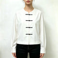 Model wearing white round neck cropped shirt with black trousers
