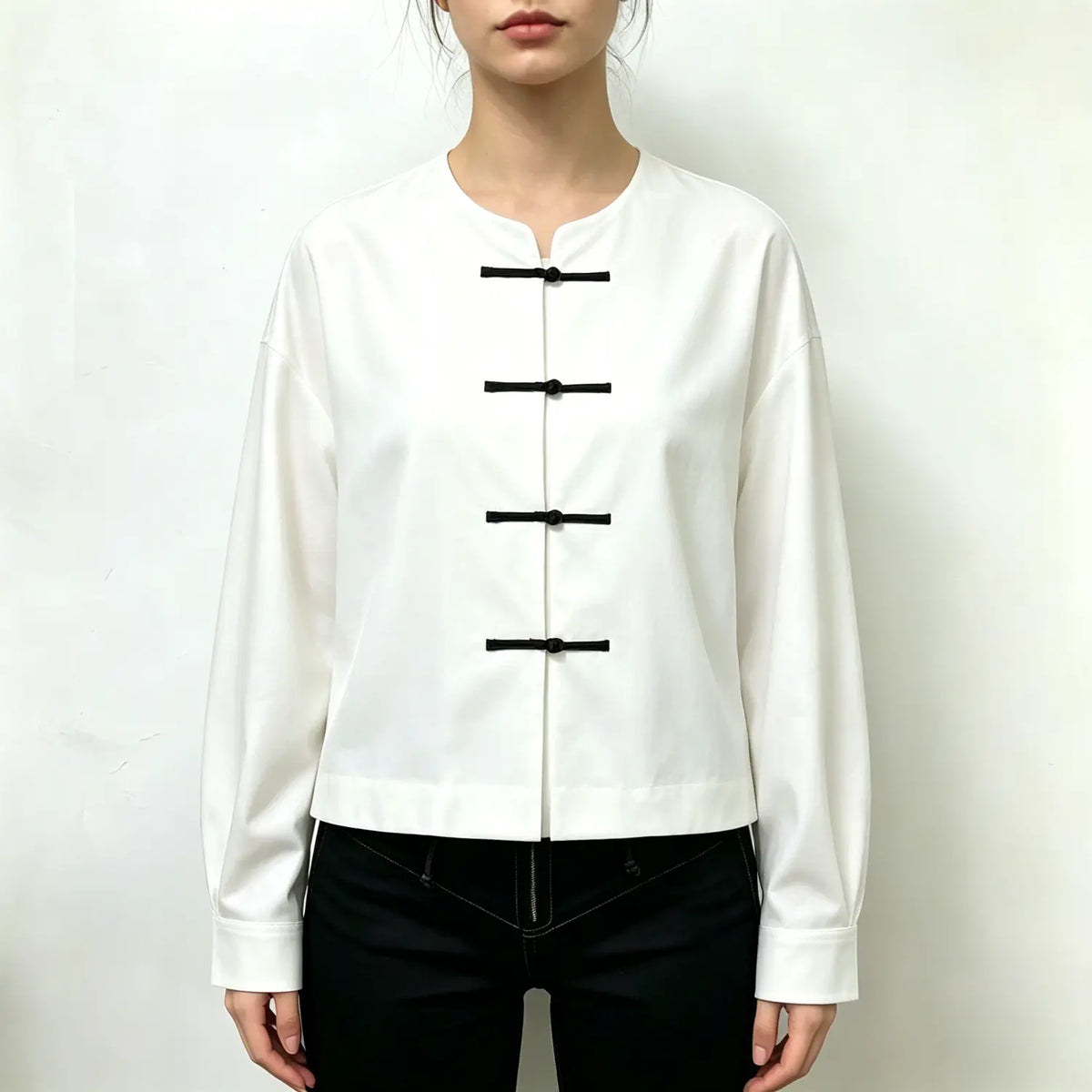 Model wearing white round neck cropped shirt with black trousers