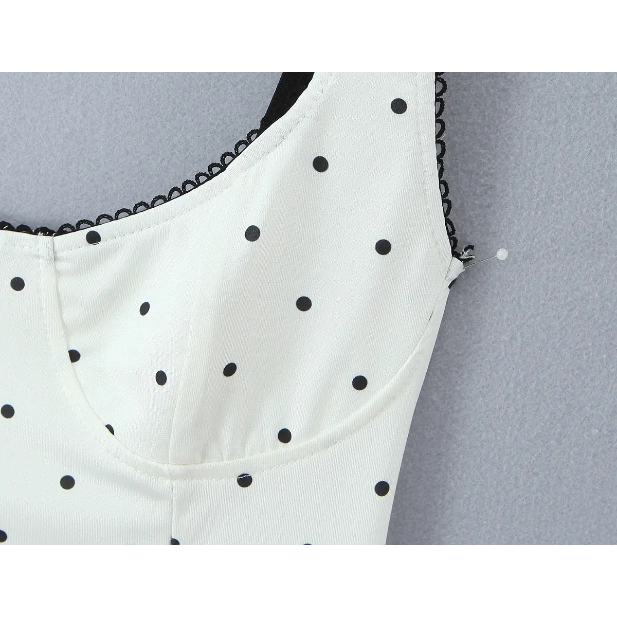 Close-up of the bust cup construction and scalloped lace trim along the neckline.