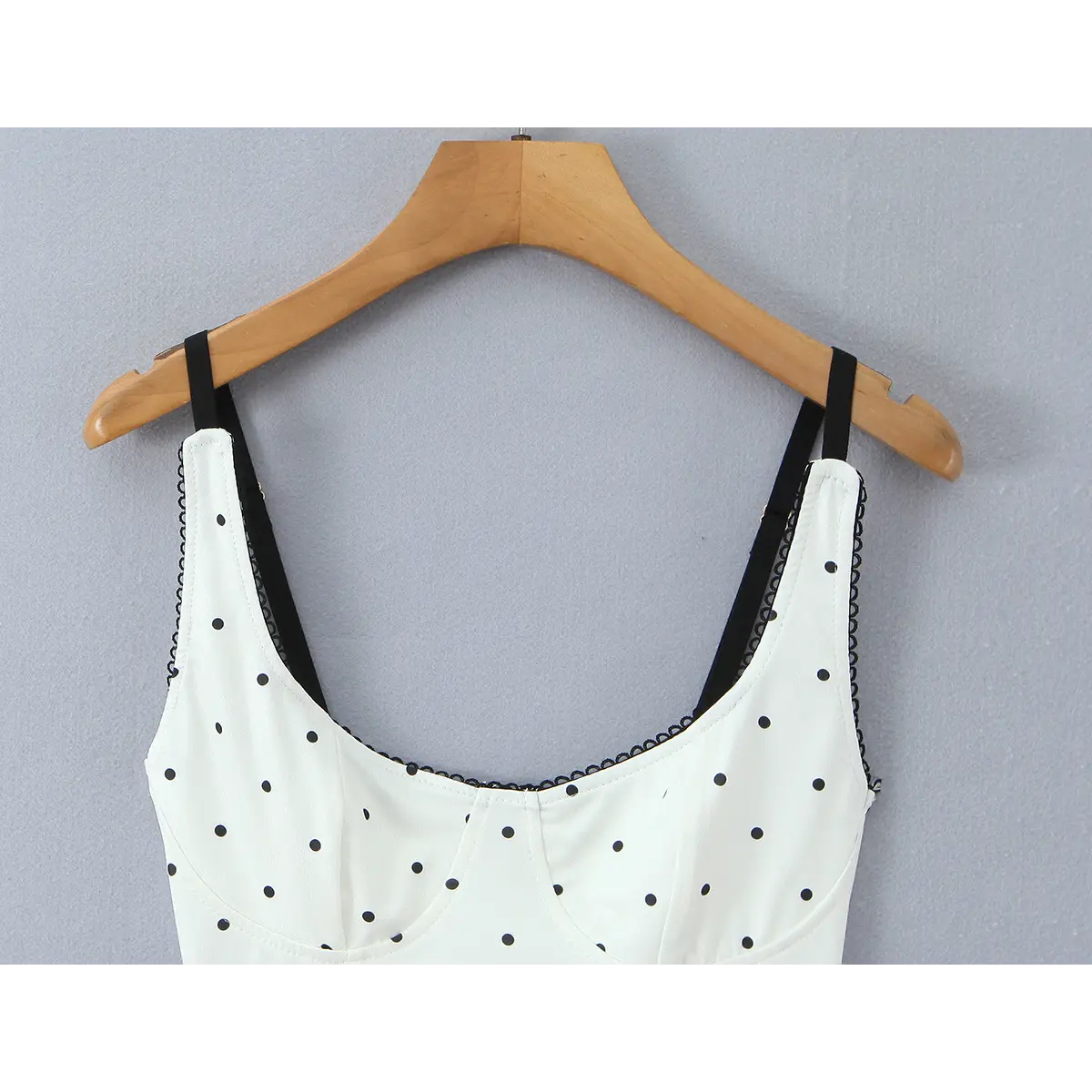 Close-up of the sweetheart neckline, showing the black lace trim and structured bust cups.