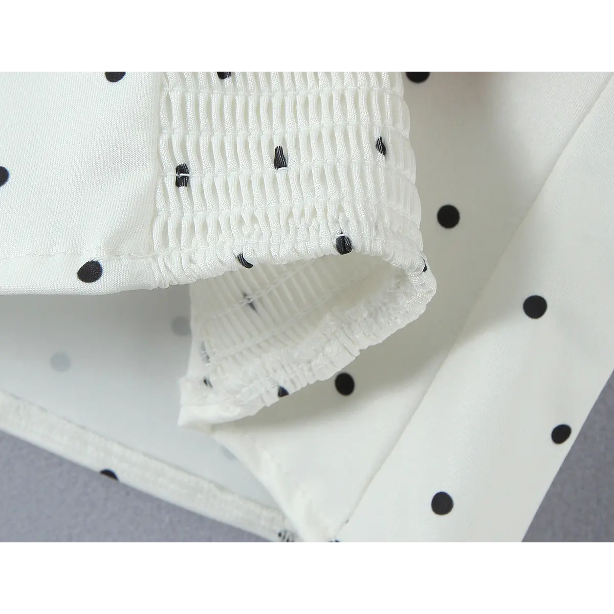 Close-up of the smocked panel on the back, showing the gathered fabric and stretchy texture.