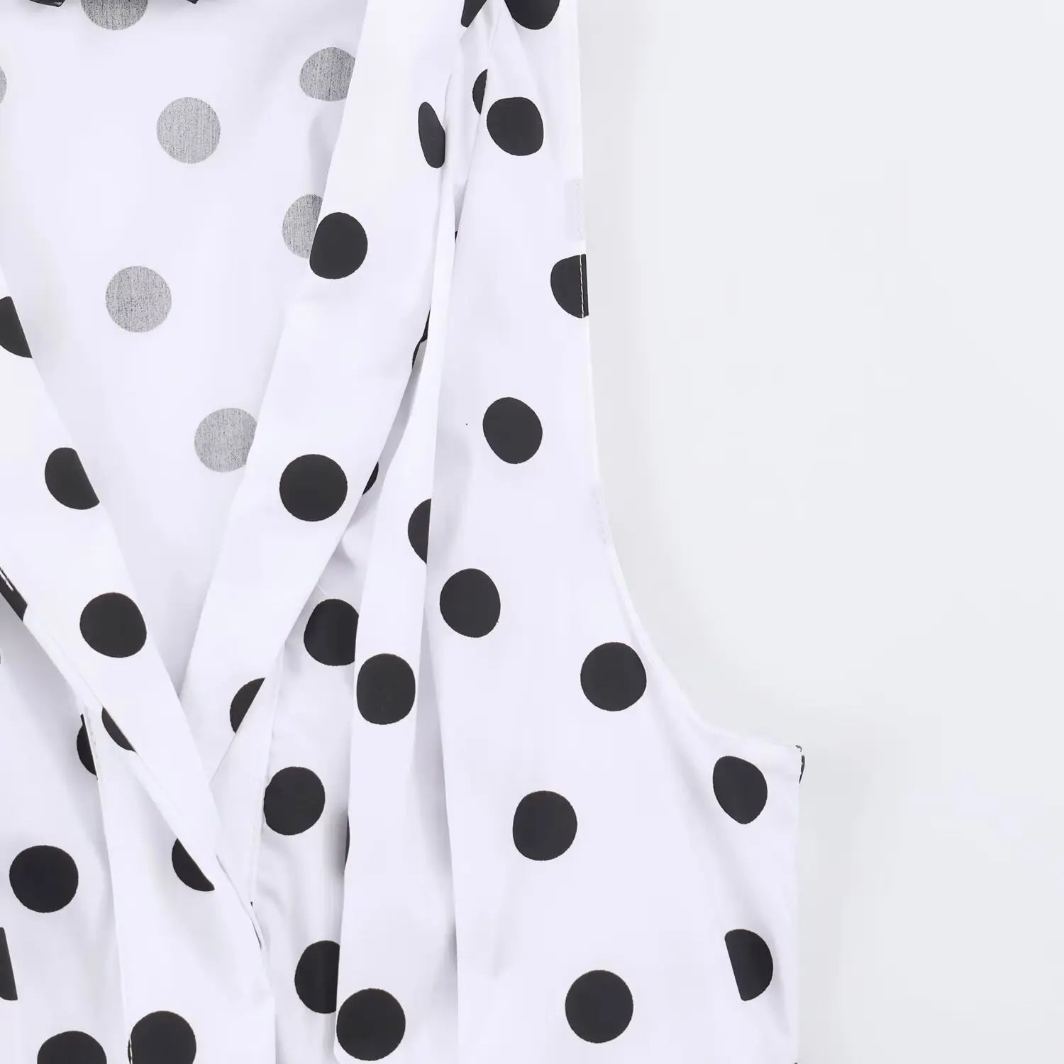 Close‑up of armhole stitching on white black polka dot sleeveless maxi dress