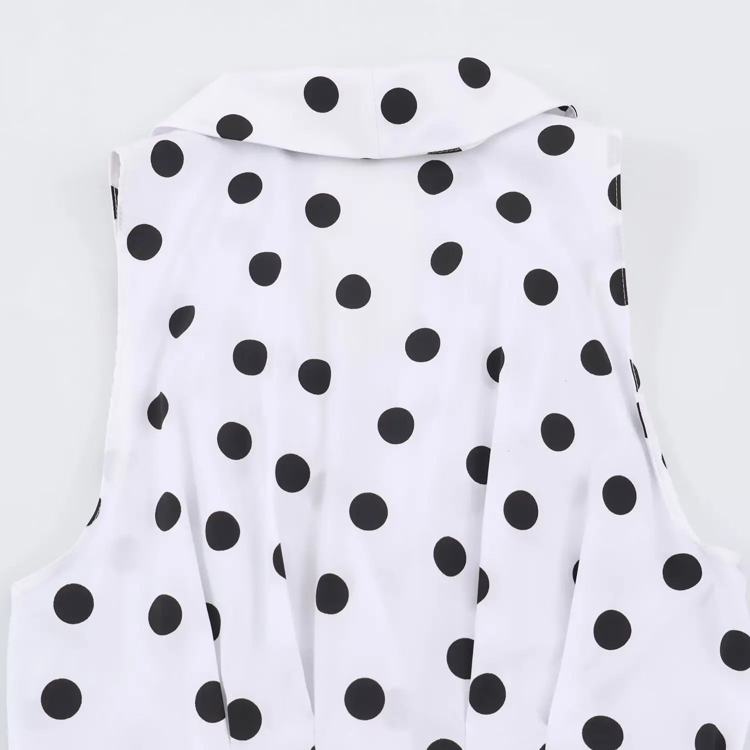 Close‑up back upper view of white sleeveless maxi dress with black polka dot print