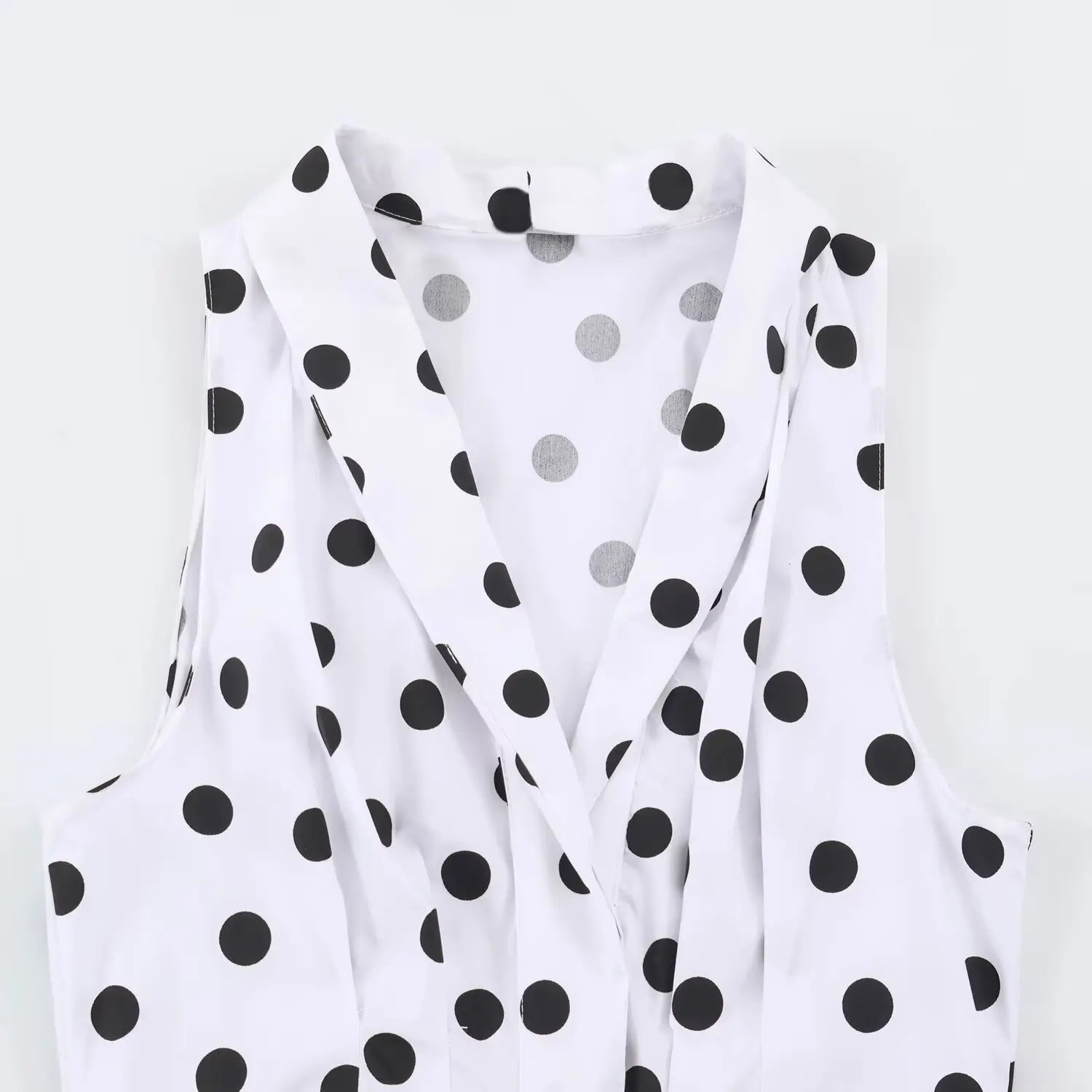 Close‑up of wrap v‑neck collar on white black polka dot sleeveless maxi dress