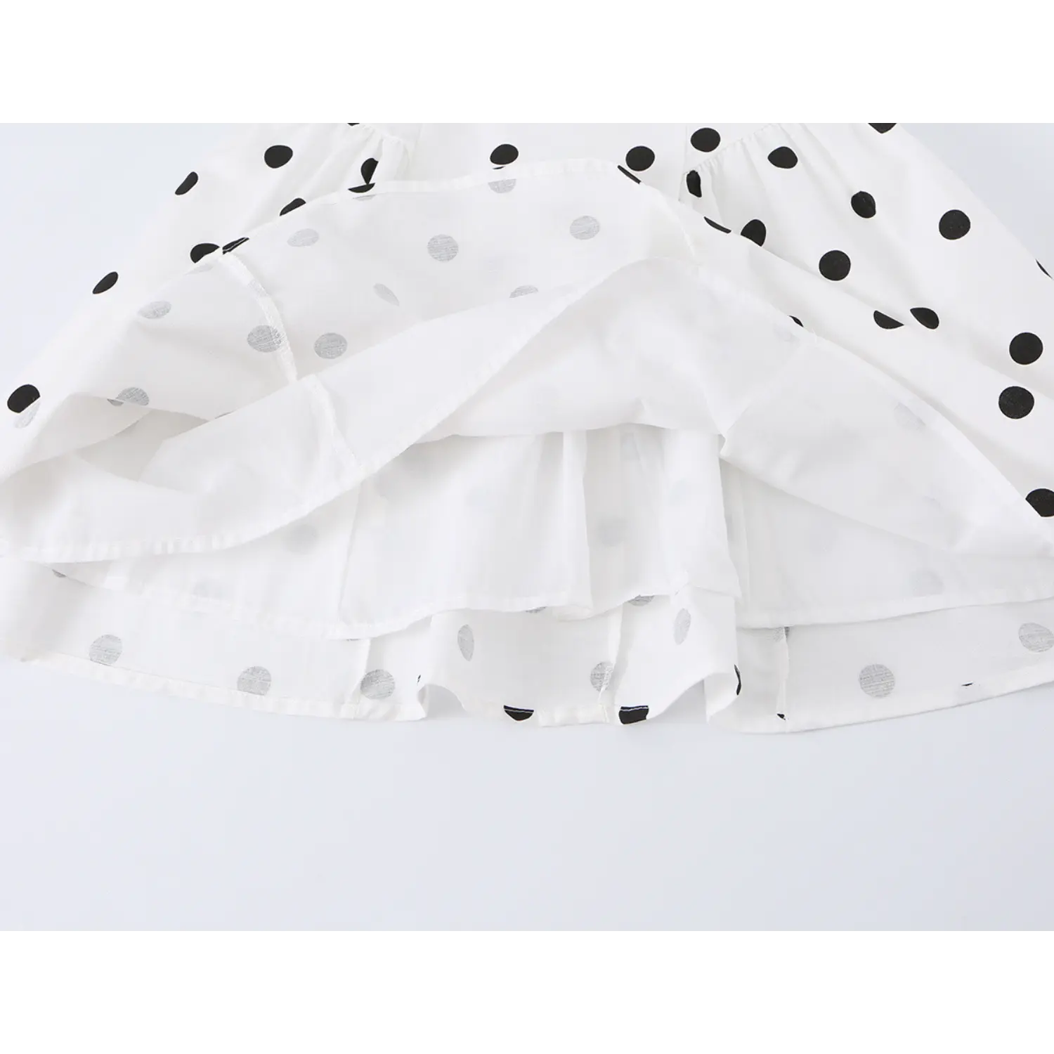 White black big polka dot mini cami dress skirt flat close-up, double woven lining a-line flared dot fabric overlock stitching white background shot