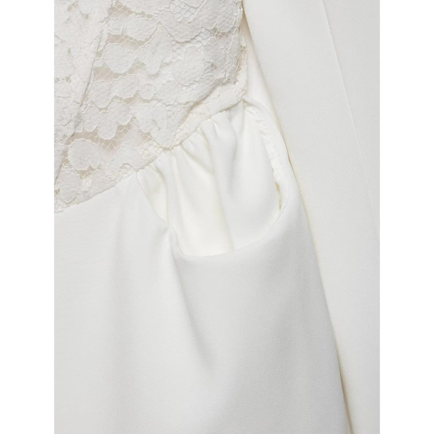 Detail shot of side pocket on white blazer dress, lace corset waist above gathered pocket design