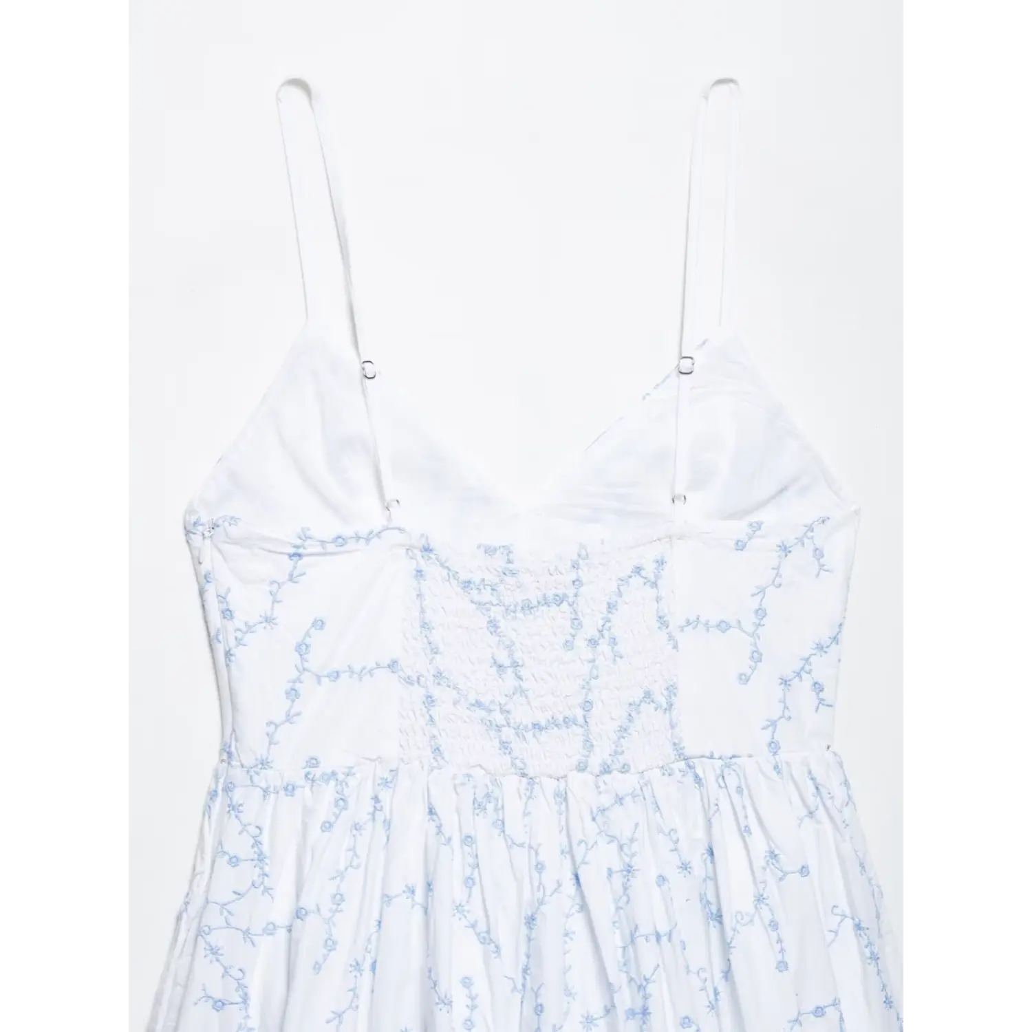 Back smocked elastic waist closeup white spaghetti strap embroidered mini dress