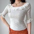 Front full shot of white mesh fitted shirt, wide neck with double ruffle, flared elbow sleeves, everyday casual feminine top