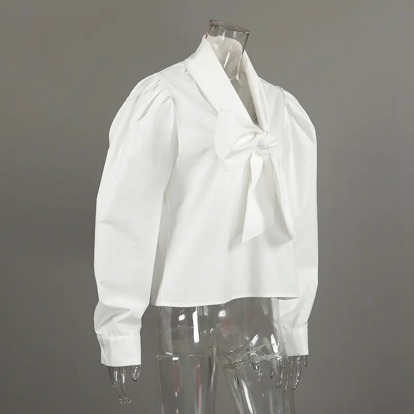 White bow neck puff sleeve cropped blouse on mannequin, three quarter view