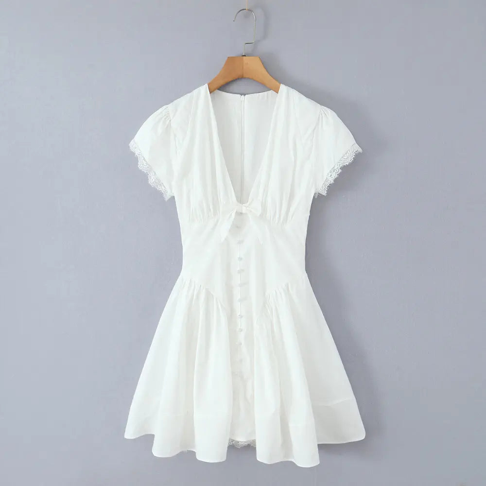 White bow v neck lace trim mini dress on hanger, front view