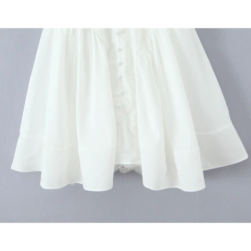 Close-up of flared skirt hem and button placket