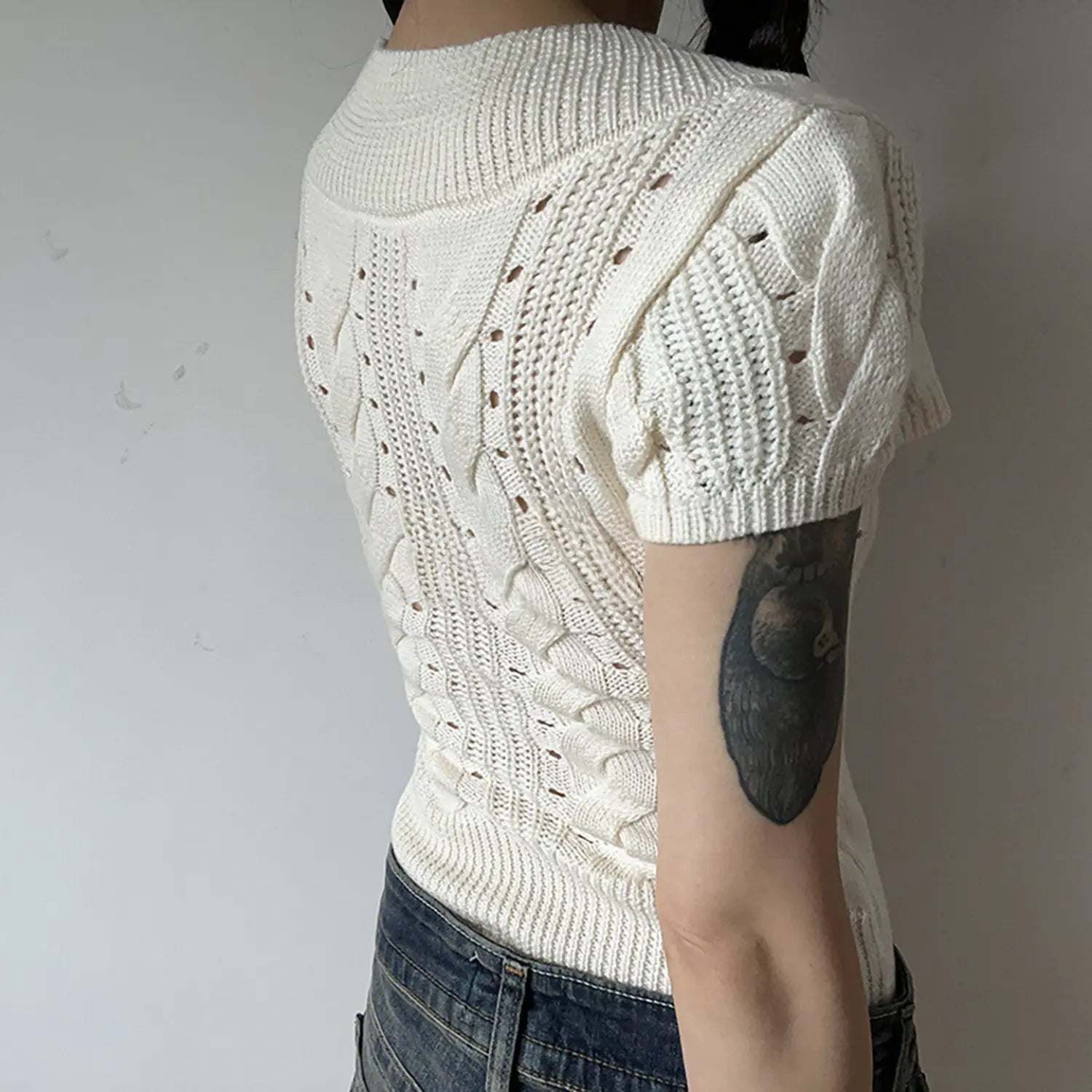 White vertical cable twist knit short sleeve crop top back detail, ribbed hem fitted women lightweight knit tee