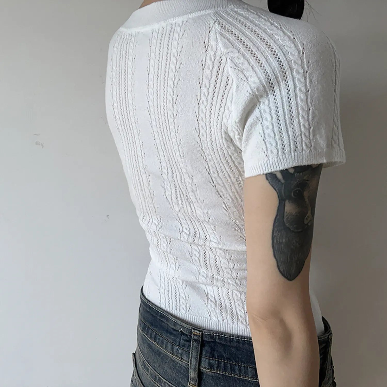 White vertical cable twist knit short sleeve crop top back detail, ribbed hem fitted women lightweight knit tee