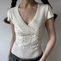 White cable twist knit short sleeve cropped top, deep v neck slim fit ribbed hem women casual knit tee front angle view